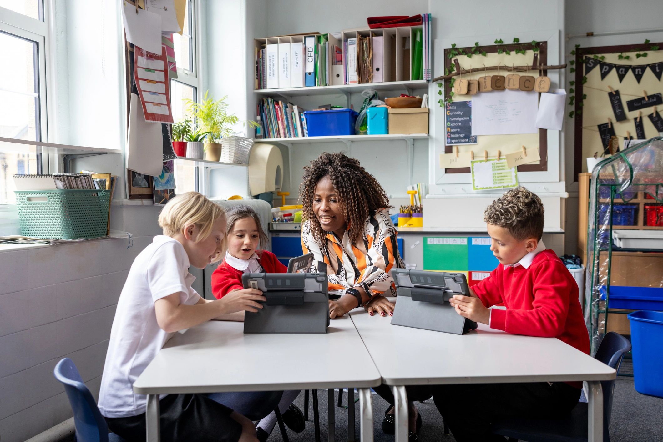 Teacher and students using tablets during a lesson