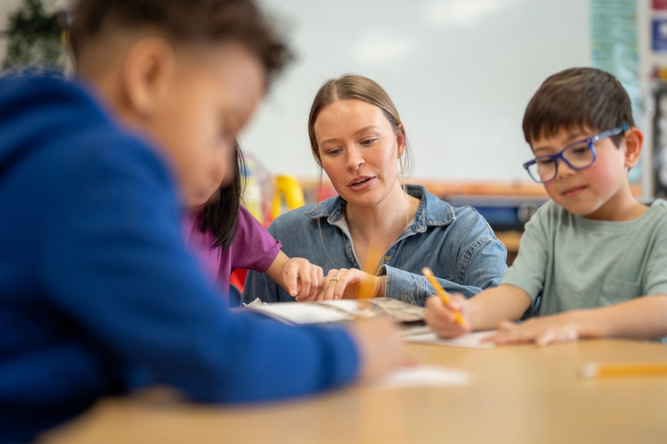 Teacher guiding children during a classroom learning activity